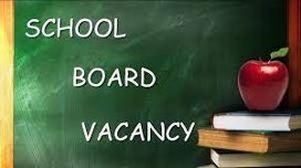 Chalkboard with the words "school board vacancy" written on it, accompanied by a stack of books and a red apple on the lower right corner.